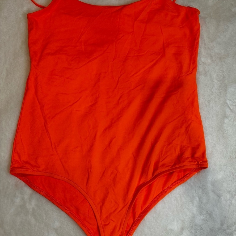 Vibrant Orange womanโs One Piece bodysuit